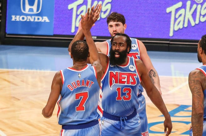 James Harden and Kevin Durant celebrate during his Brooklyn Nets debut